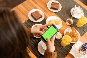 Anonymous woman shooting breakfast food