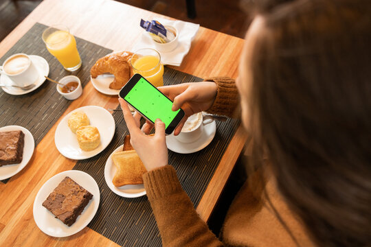 Anonymous woman shooting breakfast food