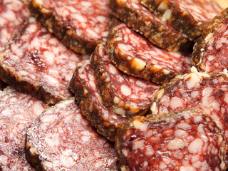 Chunks of dried sausage taken in macro. Meat products. Delicious smoked sausage.
