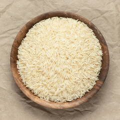 A bowl of long grain rice. Top view, close-up.