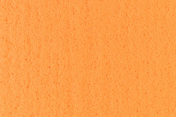 Orange washing rag background. Close-up, full frame photo.