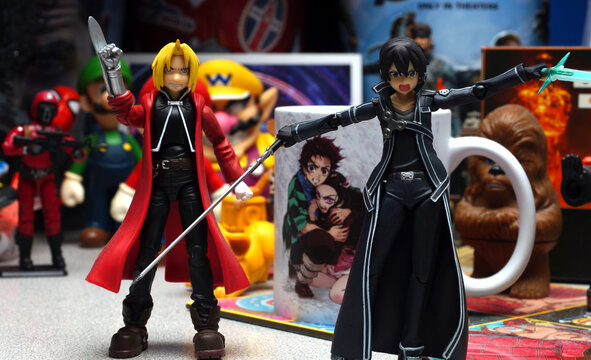 Two Anime Figurine Characters posed on a desk with other toys and objects in the background (NC State, 2022)