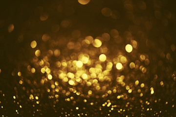 Fototapeta na wymiar Golden glitter bokeh lighting texture Blurred abstract background for birthday, anniversary, wedding, new year eve or Christmas