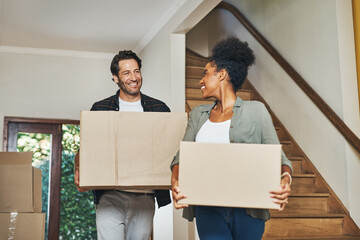 Couple homeowners moving in, carrying boxes and unpacking in new purchased home as real estate...