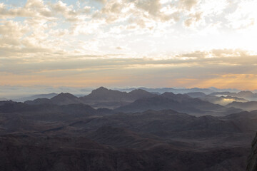 Fototapeta na wymiar Amazing Sunrise at Sinai Mountain, Mount Moses with a Bedouin, Beautiful view from the mountain