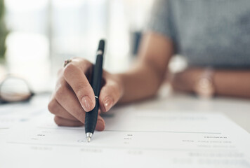 Writing, reading and making notes on finance, investment or tax contract and paperwork in an office. Hands closeup of a female financial worker planning, signing and working on banking forms