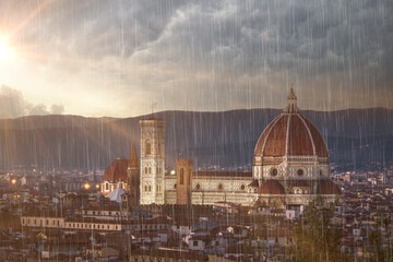 Fototapeta premium Florence city view rain clouds and sun beams on sky famous architecture of touristic destination 