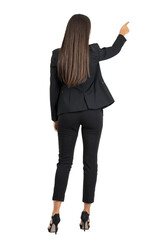 Rear view of long dark hair beauty pointing or presenting on her right side isolated	on transparent...