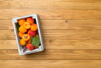 Composition with ripe apricots on wooden background, top view