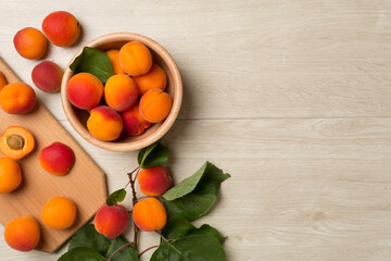 Composition with ripe apricots on wooden background, top view