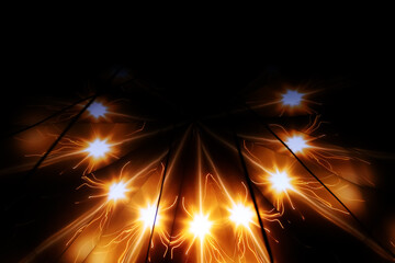 Orange laser projection with stars on a dark background. Pattern with bright stars and glowing rays. Blurred image