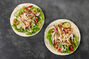 Tortillas, Flatbread with chicken meat, lettuce, tomatoes, cheese, sauce. Easy to cook sandwich.