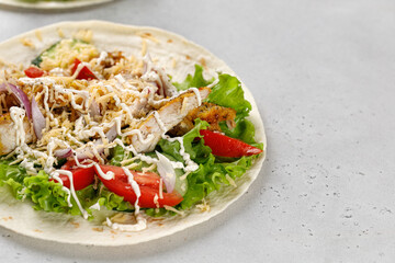 Tortillas, Flatbread with chicken meat, vegetables, lettuce, cheese, sauce. Easy to cook sandwich. Copy space.