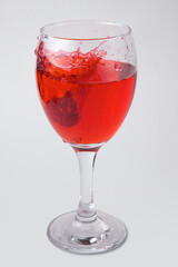 raspberry fruity mix splash glass of wine red liquid fruit splashing berry drink on white background
