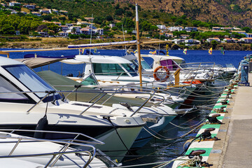 Small boats docked in the marina of a picturesque village on the Costa Brava, Port de la Selva, Catalonia.