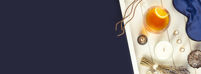 Obraz premium Healthy sleep banner with sleeping mask, lavender, candle, copy space