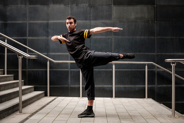 Young male dancer performing in an urban environment.
