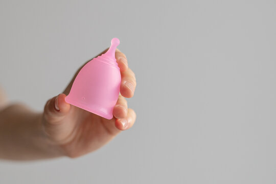 Woman's Hand Holding A Menstrual Cup Close-up