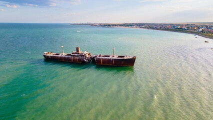 Drone photography of a rusty shipwreck at the Black Sea located next to Costinesti beach, in...