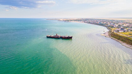 Drone photography of a rusty shipwreck at the Black Sea located next to Costinesti beach, in...