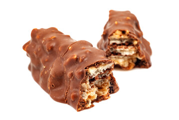 Chocolate waffle bar with nuts on a white background. Chocolate candy broken in two