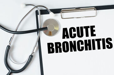 On a white surface, a stethoscope and a tablet with an inscription - Acute bronchitis