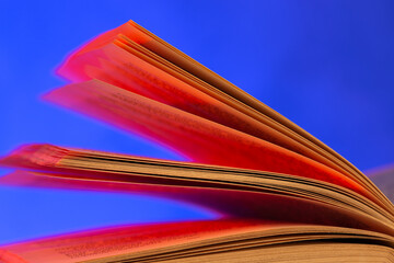 Open book close up macro photo. Wisdom and education concept.Love reading. Retro neon light 90s