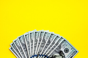 Cash on the table, yellow background, fan of money, us dollars, place for text, flat lay,  space for text