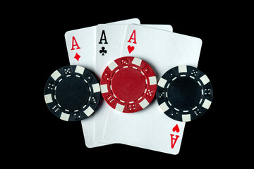 Poker game with three of a kind or set cards combination. Chips and cards on a black table in a poker club. Luck or fortune in the play.
