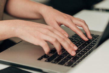 Fototapeta na wymiar Close-Up Shot of Human Hands Placed Over Laptop