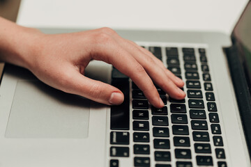 Obraz na płótnie Canvas Close-Up Shot of Human Hands Placed Over Laptop