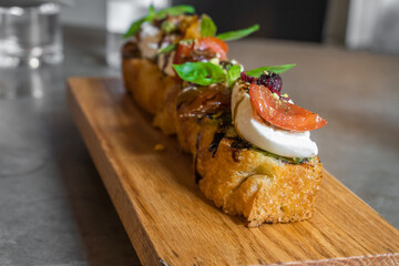 Focaccia with burrata cheese, tomato and olive oil.