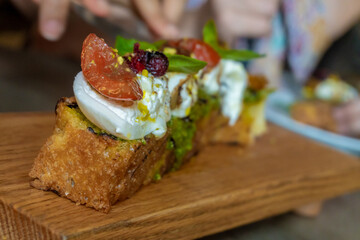 Focaccia with burrata cheese, tomato and olive oil.