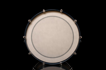drum head of bass drum on a black background with reflection, for advertising and inscription - obrazy, fototapety, plakaty