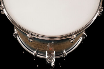 part of beautiful flour tom drum on a black background with reflection, for advertising and inscription