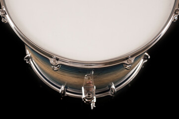 Fototapeta na wymiar part of beautiful tom drum on a black background with reflection, for advertising and inscription