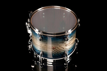 beautiful tom drum on a black background with reflection, for advertising and inscription