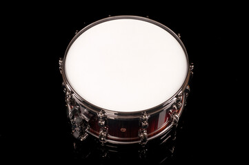 Fototapeta na wymiar beautiful snare drum on a black background with reflection, for advertising and inscription
