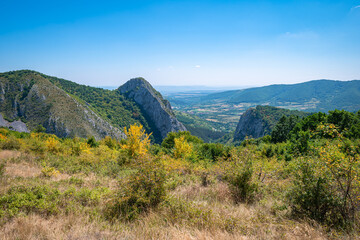 Fototapeta na wymiar View from The Trascău Mountains on the valley and mountains near Vălișoara in Transylvania, Romania in southwesterly direction.