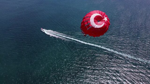 Parasailing footage with the Turkish flag pattern taken with a drone.