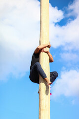 a person on a ladder or pole climbs up
