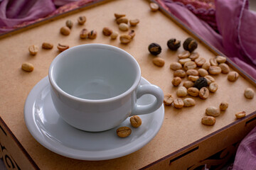 white porcelain cup and coffee beans