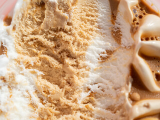 Caramel ice cream on a pink background.