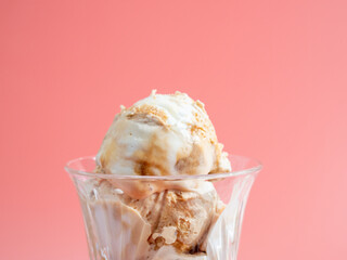 Caramel ice cream on a pink background.