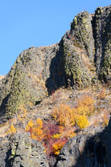 Basalt cliffs with fall colors and blue sky in Central Washington State