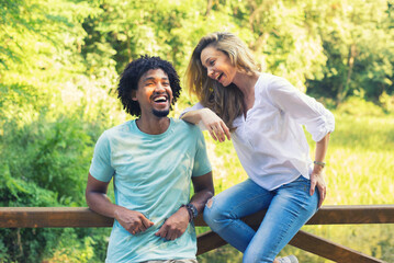 Young mixed race couple talking while standing in the summer nature