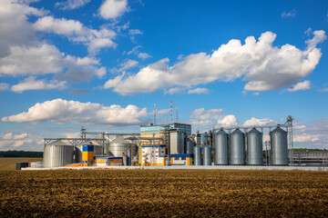 Agricultural Silos. Storage and drying of grains, wheat, corn, soy, sunflower against the blue sky...