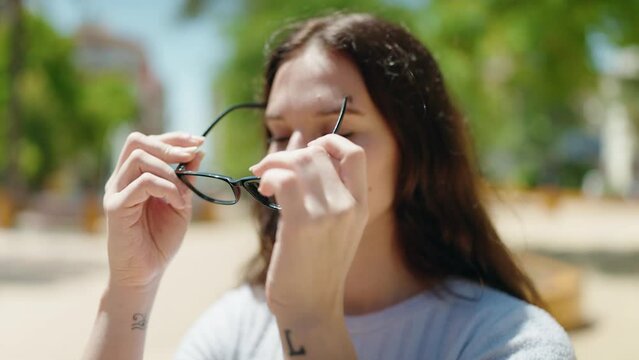 Young woman smiling confident wearing glasses at park