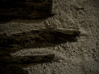 imagen textura pared de cemento con piedras clavadas 