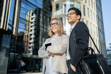 Business colleagues meet a team a woman and a man in business suits go to the office